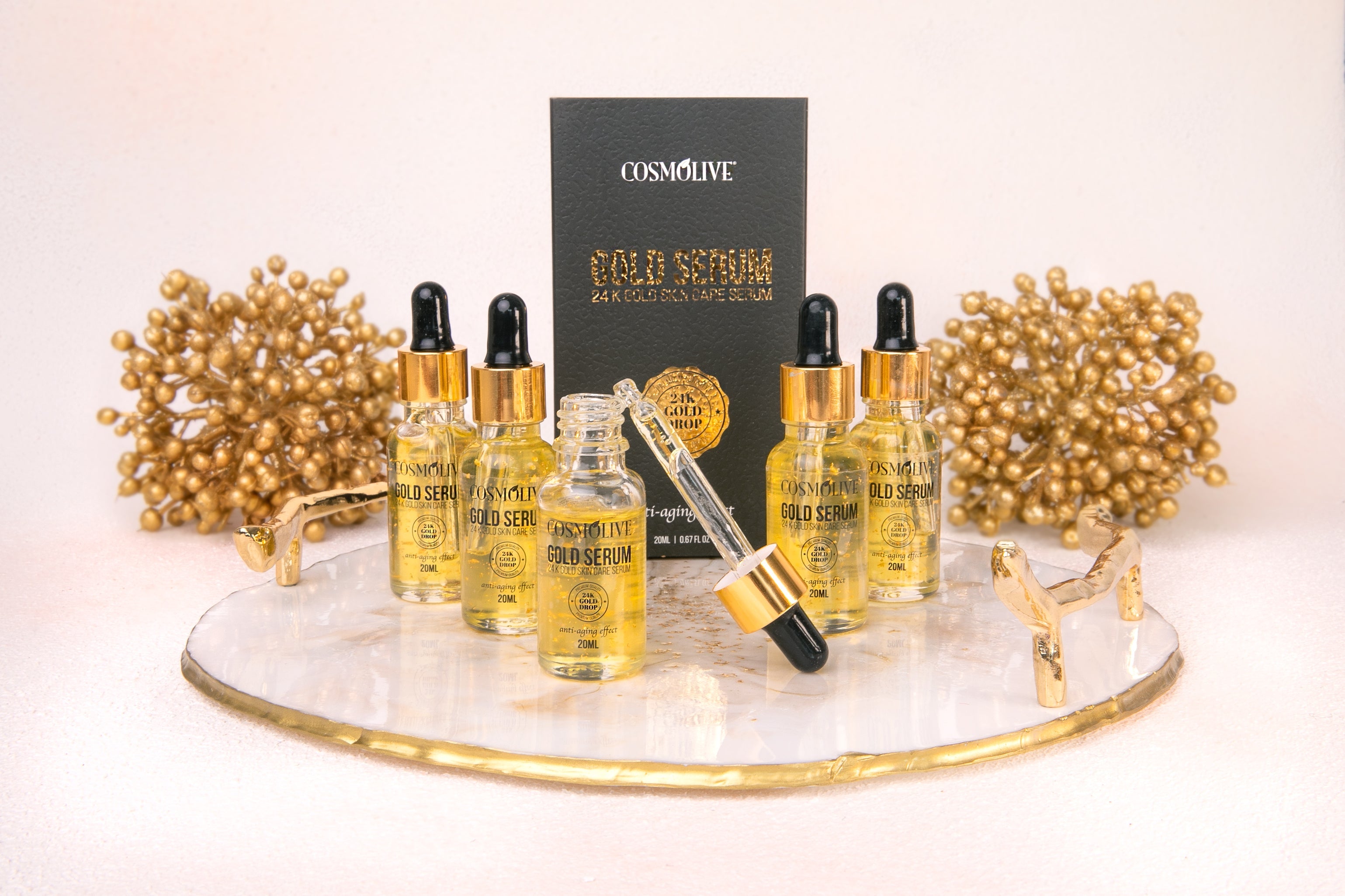 Cosmolive 20ml Gold Serum with 24K Gold, designed to enhance youthful complexion. Vegan, paraben-free, and not tested on animals, it deeply nourishes the skin for a radiant and rejuvenated look.